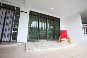 Enter a serene space with a sliding glass door leading to an outdoor area.