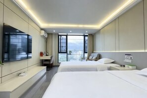 A hotel room with two beds, a TV, a desk, and a balcony with a view. - Xiangyuan Hot Spring Hotel (Rucheng)