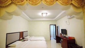 A hotel room with two beds, a desk, and a television. - Xiangyuan Hot Spring Hotel (Rucheng)