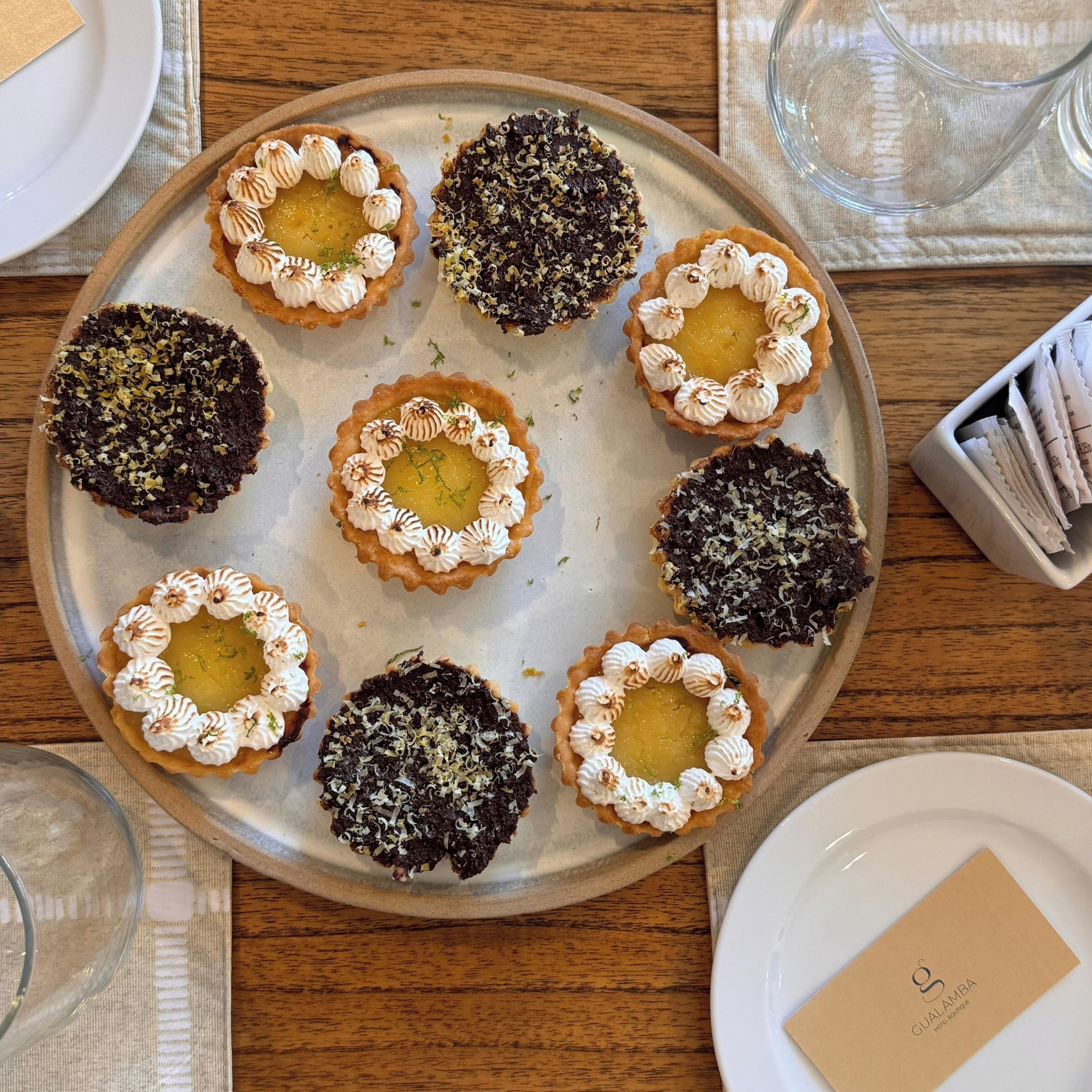A tray of assorted tarts on a table.