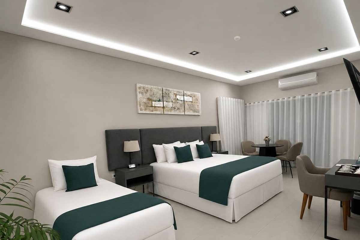 A modern hotel room with two beds, a desk, and a chair.