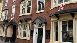 A traditional brick building with a sign for 'The Talbot Hotel' and a 'Car Park at Rear' sign. - The Talbot Hotel (Stourbridge)
