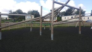 A playground with a climbing structure and a fenced area. - 2 Bed Lodge - Sleeps 6 - Parking - Pets - Wifi (Millom)