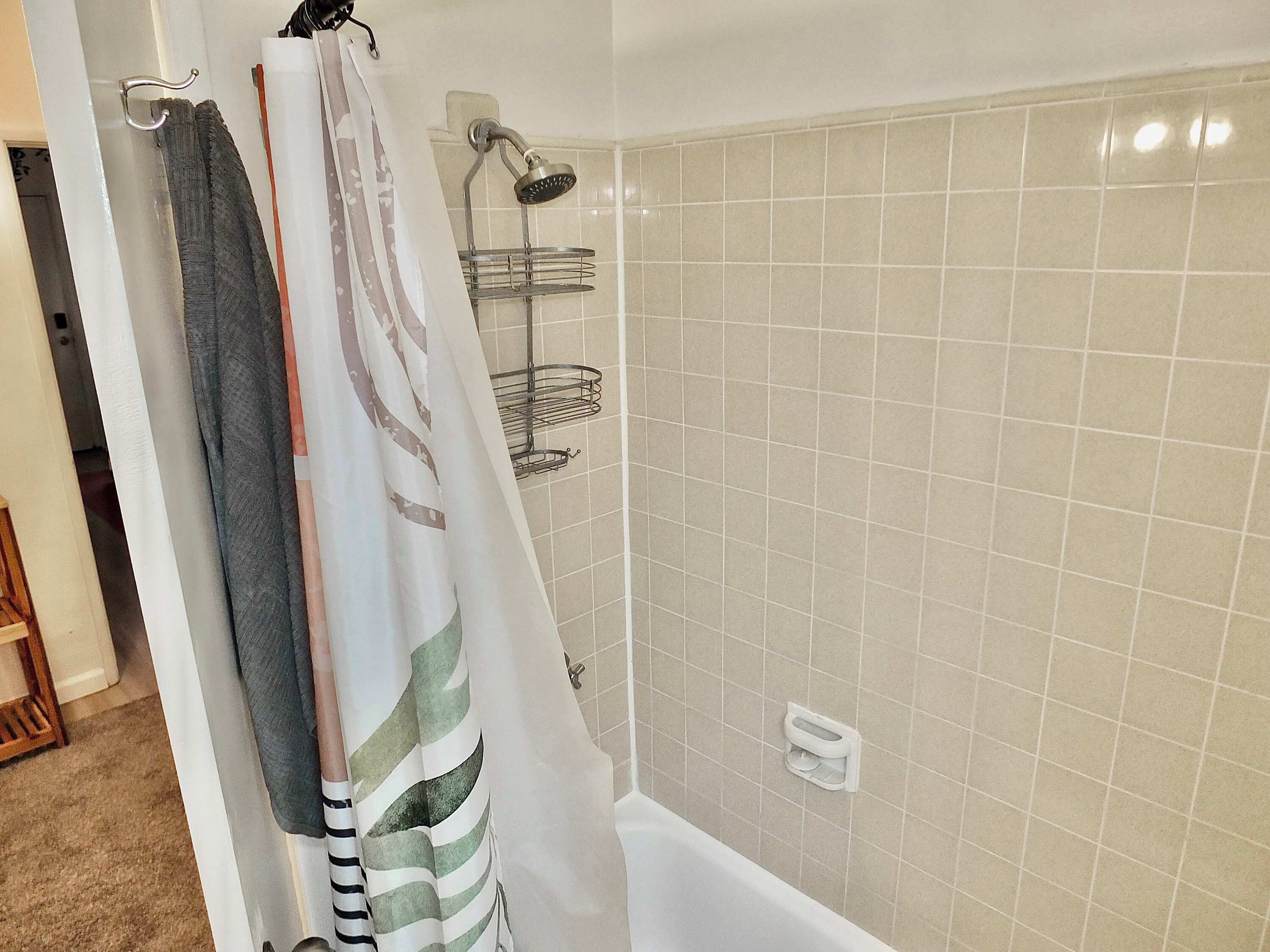 The full bathroom includes a single vanity & shower/tub combo