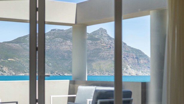 Une chambre avec vue sur la montagne et la mer.