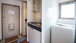 A compact kitchen with a dishwasher, a sink, and a window. - Daikoku Apartment 603 - Namba Apt3 minJR Imamiya/Daikokucho St/Veranda (Osaka)