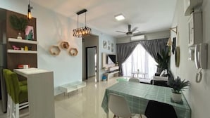 A modern living room with a dining area, a kitchen, and a ceiling fan. - Prestige Sky Riverfront (Kota Bharu)