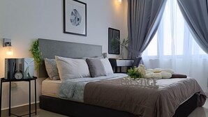 A modern bedroom with a bed, a side table, a clock, and a framed picture on the wall. - Prestige Sky Riverfront (Kota Bharu)