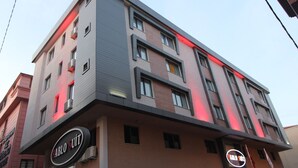 A multi-story building with a modern architectural design, featuring a prominent "Pablo Suite" sign on the ground floor. - PABLO SUIT AVCILAR (Istanbul)