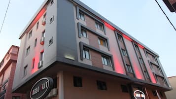 A multi-story building with a modern architectural design, featuring a prominent "Pablo Suite" sign on the ground floor.