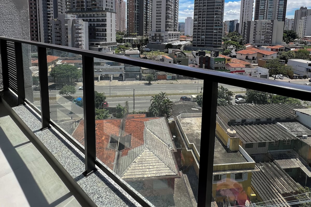 A high-rise building with multiple floors, large windows, and a clear view of the cityscape.