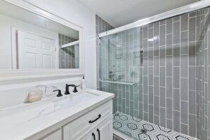Shower, hair dryer, towels, shampoo