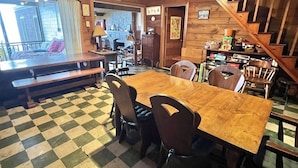 A cozy room with a checkered floor, wooden furniture, and a staircase. - LARGE RUSTIC COTTAGE WITH BUNK HOUSE.  SLEEPS 17.  (Sebago)