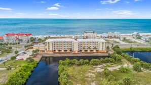 A coastal hotel with multiple buildings, a marina, and a view of the ocean. - Mexico Beach - Summerhouse by PHG (Port St. Joe)