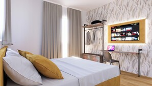 A modern hotel room with a bed, a desk, and a mounted TV displaying a Netflix interface. - The Place Vaticano 278 (Rome)