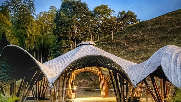 A modern architectural structure with a unique curved roof design, surrounded by a landscaped garden with pathways and plants. - CasaMarella Exclusivity+HouseBoutique+Hydromassage

 (Morelia Pereira)