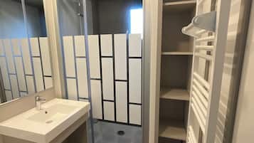 Shower, hair dryer, towels, toilet paper