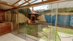 Enjoy a meal on the patio, where a brick barbecue area with a chimney invites outdoor dining.