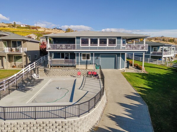 Guests can enjoy a balcony with a view of the surrounding landscape from this two-story residence.