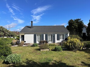 Stroll through the serene surroundings of this single-story home, complete with a patio area and well-manicured lawn.