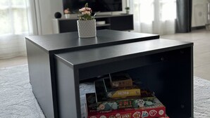 A modern living room with a black entertainment unit, a flat-screen TV, and a vase with flowers on top. - Charming Datcha in Normandy  (Les Damps)