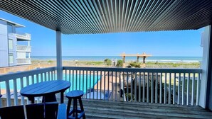 A wooden deck with a view of the ocean, a pool, and a gazebo. - Sea Colony B7-one bedroom one bath, 1st floor, oceanfront rental located in Carolina Beach with panoramic views (Carolina Beach)