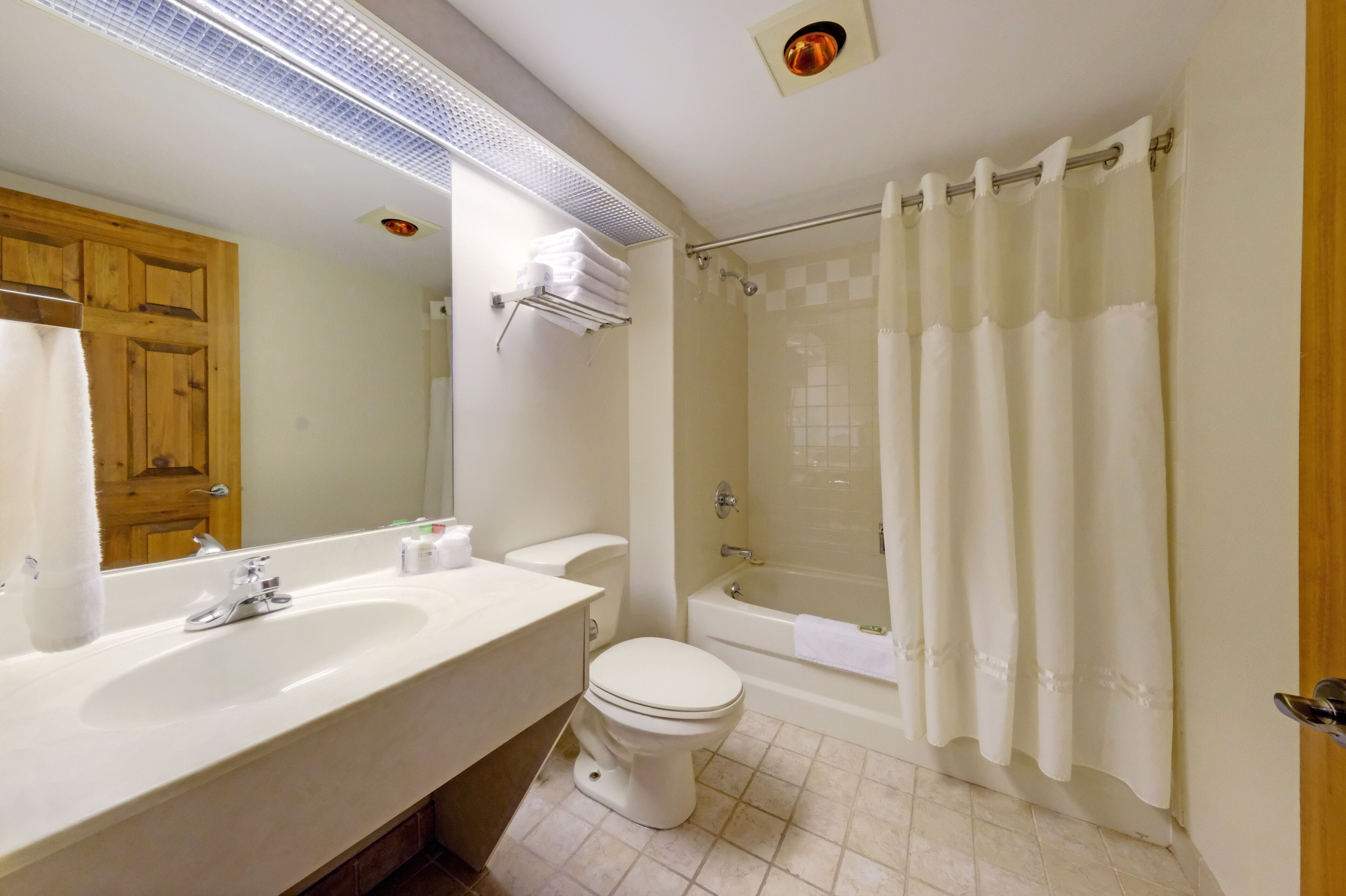 A bathroom with a sink, toilet, and bathtub.