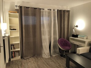 Relax and work in style with a spacious desk and comfortable reading chair.