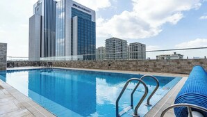 A rooftop pool with a view of JW Marriott hotel buildings in the background. - Elite - 1 bedroom - pool & Gym

 (Nairobi)