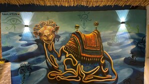 A mural with a camel and abstract designs on a wall. - Farida Pyramids Boutique Hotel (Giza)