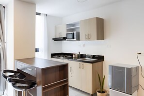 Fridge, microwave, coffee/tea maker, cookware/dishes/utensils