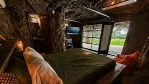 A room with a bed, a TV, a desk, and a window with a view. - LockRidge Park (Lancaster)
