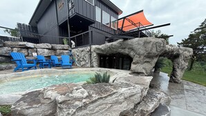 A modern building with a pool, blue Adirondack chairs, and a rock feature. - LockRidge Park (Lancaster)