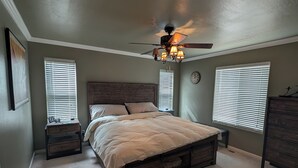 A bedroom with a bed, two nightstands, a ceiling fan, and two windows with blinds. - HIDDEN SPACIOUS 4-bdr RETREAT FOR FAMILIES AND FRIENDS!  (Show Low)