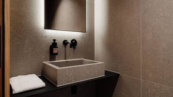A modern bathroom with a rectangular sink, a mirror, and a towel.