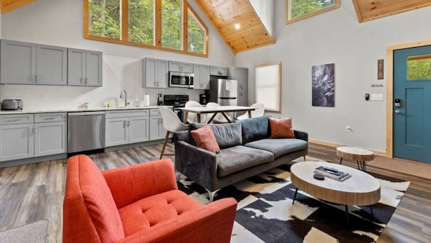 A modern interior with a kitchen, dining area, and living room.