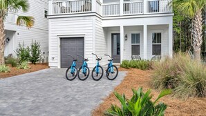 A two-story house with a covered porch and a garage. - Guest Favorite Beach Beauty with Bunks SLPS 8! (Inlet Beach)
