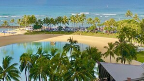 A beach view with a pool, palm trees, and a rainbow. - Oceanfront Paradise (Car Available) (Honolulu)