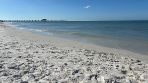 A beach with a pier extending into the water. - Paradise awaits! Heated pool, huge lanai, outdoor oasis close to downtown Naples (Naples)