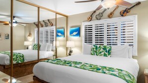 A hotel room with a large bed, a ceiling fan, a mirror, and a window with shutters. - Kihei Ali'i Kai D202 1 Bedroom Condo (Kihei)