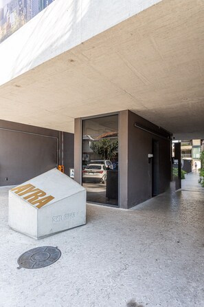 Una estructura de concreto con una caja blanca que dice 'SKR 2028' y una rejilla metálica en el suelo.