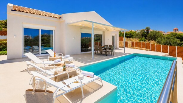 A modern villa with a swimming pool, outdoor seating, and a covered patio. - Casa di Pietra - Two Bedroom Villa, Sleeps 4 (Lakithra)