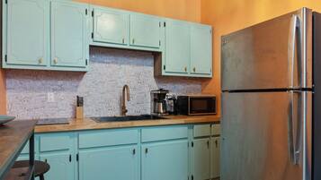 Fridge, microwave, coffee/tea maker, cookware/dishes/utensils