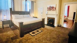A bedroom with a bed, a ceiling fan, a fireplace, and a nightstand. - Relax and escape in this vibrant Columbus apartment (Columbus)