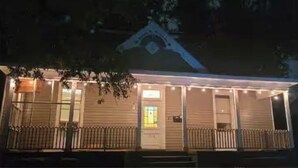A building with a porch, a door, and a window. - Relax and escape in this vibrant Columbus apartment (Columbus)