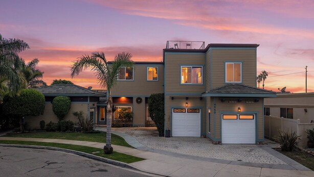 A two-story house with a garage, a driveway, and a well-maintained lawn. - Oxnard Beach Retreat  (Oxnard)