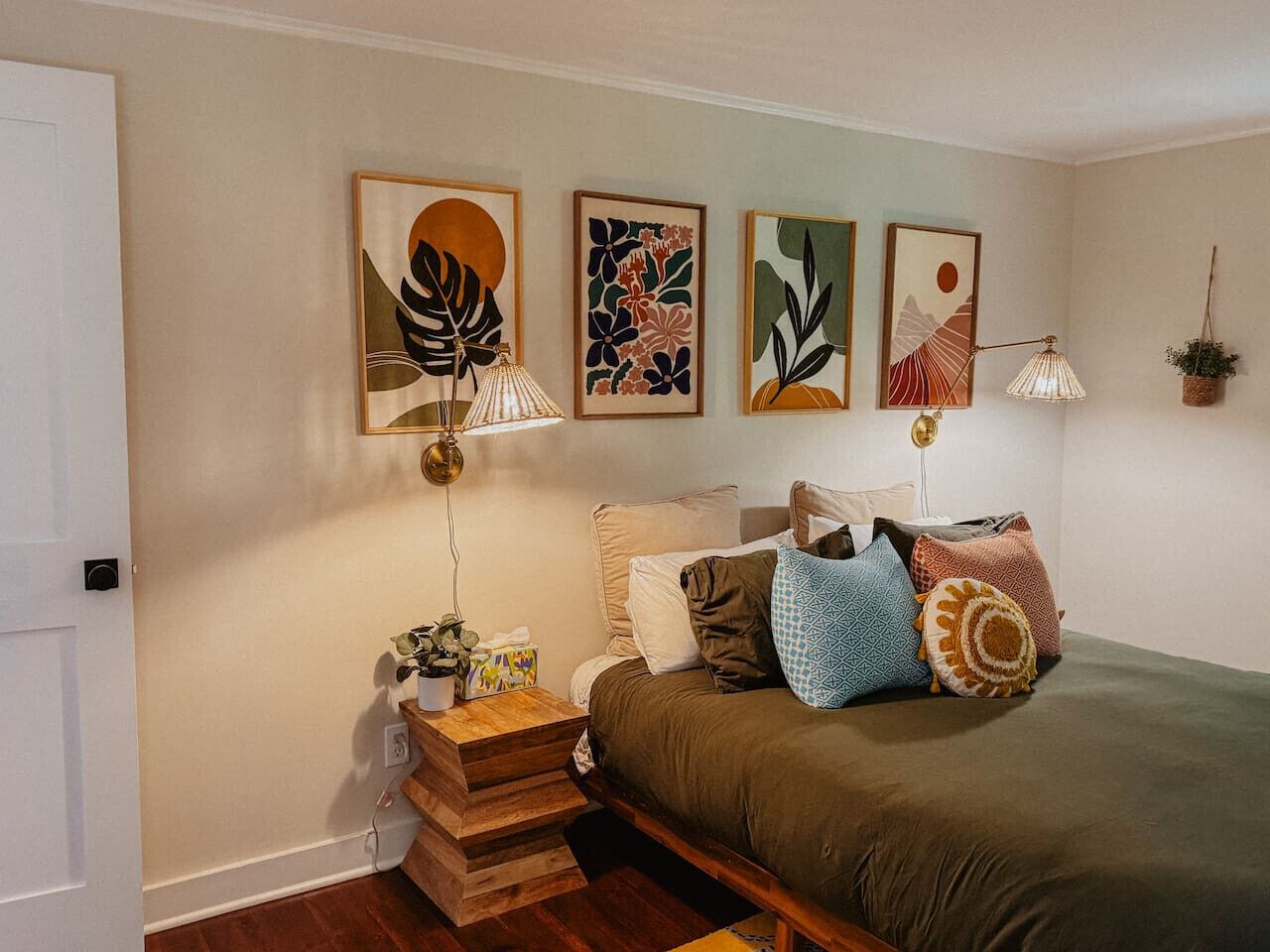 Un dormitorio con cama, mesitas de noche y decoración en la pared.