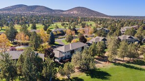A residential area with houses, trees, and a mountain in the background. - Eagle Crest Hole in One! (Redmond)