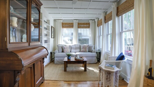 A cozy living room with a sofa, coffee table, and a wooden cabinet. - 4 Mi to Dtwn: Baton Rouge Bungalow w/ Private Yard (Baton Rouge)