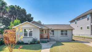 A single-story house with a front porch, a small garden, and a clear sky. - 1 Mi to Dtwn: Home w/ Furnished Patio in Pensacola (Pensacola)